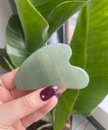 Gua sha is a modality of traditional Chinese medicine that uses a stone tool that runs over the skin to break up tension due to stagnation from water retention, muscle tightness, or other congestion.
